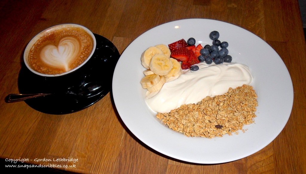 The breakfast of coffee and fruit granola at Grind Coffee Bar