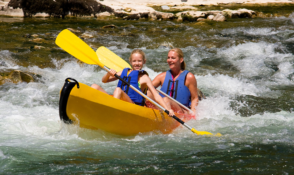 Ardeche Gorge canoe river rapids parent and child paddling