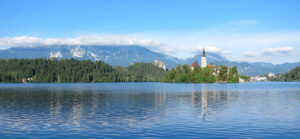 Where in the World 562 Featured image Lake Bled, Slovenia, castle and church mountains Julian Alps