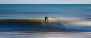 Where in the World 567 featured image surfer on a wave