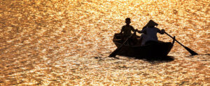 Where in the World 603 featured image fishermen in a boat on golden water reflection