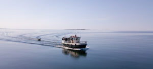 Where in the World 678 fishing boat on a calm sea