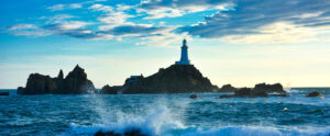 Where in the World 633 featured image lighthouse on rocks with sea and sky