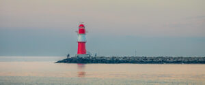 Where in the World 676 red and white lighthouse calm sea