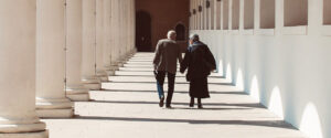 Where in the World 686 featured image two men walking down a university colonnaded alleyway.