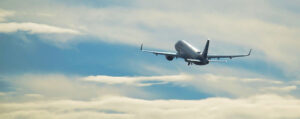 Where in the World 689 airplane above the clouds featured image