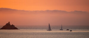 Where in the World 693 Sunset boats on water mountains