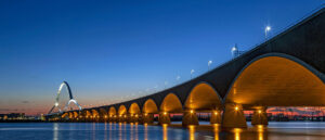Featured image Where in the World 697 bridge illuminated at night