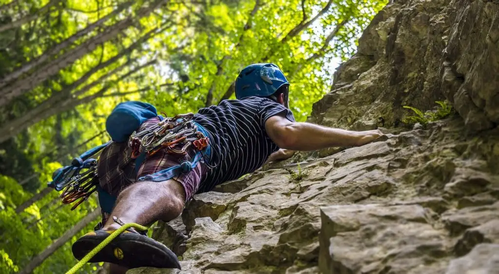 Travel Insurance rock climbing adventure mountaineering person climbing rocks