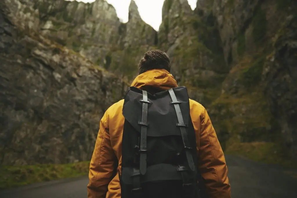 Travel insurance hiker heading into the mountains with a rucksac