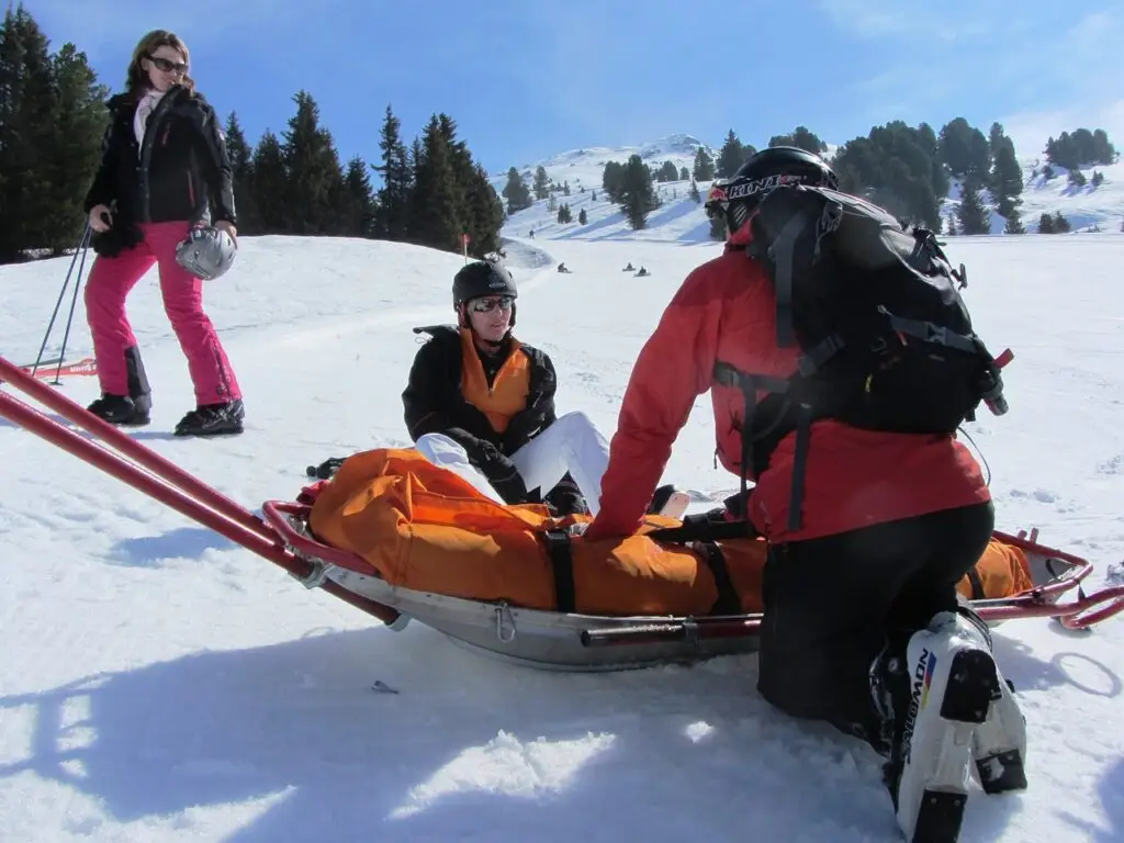 Travel insurance ski rescue on snow covered slope