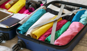 Baggage fees suitcase full of rolled clothes featured image