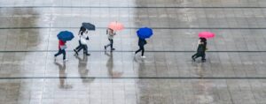 Featured image Where in the World 560 rain people umbrellas